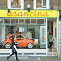 A cute orange car to advertise that Arancina is sold here